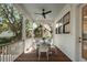 Covered porch featuring a ceiling fan, white railings, wood flooring and a dining table at 14 55Th Ave, Isle of Palms, SC 29451