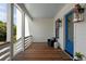 Inviting porch with blue door, wooden floors, and stylish decor at 14 55Th Ave, Isle of Palms, SC 29451