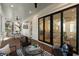 Covered porch with wood flooring, ceiling fan, seating and access to the home's interior through sliding glass doors at 14 55Th Ave, Isle of Palms, SC 29451
