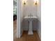 Powder room with pedestal sink and designer lighting at 14 55Th Ave, Isle of Palms, SC 29451