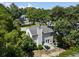 Aerial view of the home featuring mature trees, nearby street, and a large backyard at 1406 Oaklanding Rd, Mount Pleasant, SC 29464