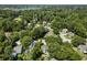 Broad aerial view of a leafy suburban area, featuring diverse houses nestled among mature trees and quiet streets at 1406 Oaklanding Rd, Mount Pleasant, SC 29464