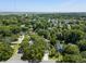 Scenic aerial view showcasing a residential community with a pond, dense trees, and a variety of charming, well-kept homes at 1406 Oaklanding Rd, Mount Pleasant, SC 29464