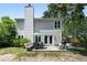 View of a backyard featuring mature trees, patio, grill, furniture, and a view of the home at 1406 Oaklanding Rd, Mount Pleasant, SC 29464