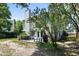 View of a backyard featuring mature trees, patio, grill, furniture, and a view of the home at 1406 Oaklanding Rd, Mount Pleasant, SC 29464