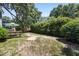 View of a backyard featuring mature trees, an enclosed yard, and some grassy areas at 1406 Oaklanding Rd, Mount Pleasant, SC 29464