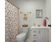 Fun bathroom with novelty shower curtain and gold fixtures on a white vanity at 1406 Oaklanding Rd, Mount Pleasant, SC 29464