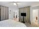 Bright bedroom features neutral walls, a ceiling fan, a large bed and an attached bathroom at 1406 Oaklanding Rd, Mount Pleasant, SC 29464