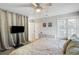 Bright bedroom features neutral walls, a ceiling fan, a large bed and a flat screen television at 1406 Oaklanding Rd, Mount Pleasant, SC 29464