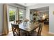 Bright dining area with access to the backyard, complemented by stylish wooden furniture and hardwood flooring at 1406 Oaklanding Rd, Mount Pleasant, SC 29464