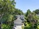 Charming home with a two-car garage and well-manicured lawn is framed by mature trees, enhancing curb appeal at 1406 Oaklanding Rd, Mount Pleasant, SC 29464
