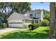 Charming two-story home featuring an attached garage, beautiful landscaping, and a welcoming front entrance with a wreath at 1406 Oaklanding Rd, Mount Pleasant, SC 29464