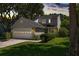 Charming two-story home featuring an attached garage, beautiful landscaping, and a welcoming front entrance with a wreath at 1406 Oaklanding Rd, Mount Pleasant, SC 29464