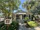 Charming home featuring a welcoming screened porch, lush landscaping, and a community library box at 1406 Oaklanding Rd, Mount Pleasant, SC 29464