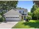 Charming two-story home with a two car garage, beautiful landscaping, and a welcoming front entrance with a wreath at 1406 Oaklanding Rd, Mount Pleasant, SC 29464