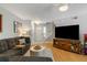 Inviting living room with plush sofa, wooden floors, and a large TV, offering a cozy space for relaxation and entertainment at 1406 Oaklanding Rd, Mount Pleasant, SC 29464