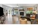Comfortable living room with a stone fireplace, plenty of natural light, hardwood floors and a modern ceiling fan at 1406 Oaklanding Rd, Mount Pleasant, SC 29464