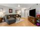 Inviting living room with plush sofa, wooden floors, and a large TV, offering a cozy space for relaxation and entertainment at 1406 Oaklanding Rd, Mount Pleasant, SC 29464
