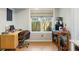 Bright office space with modern desk, accent chair, and a window view of the backyard at 1406 Oaklanding Rd, Mount Pleasant, SC 29464