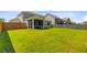 A spacious, grassy backyard featuring a screened-in porch at 142 Airy Dr, Summerville, SC 29486