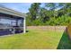 A spacious, grassy backyard featuring a screened-in porch at 142 Airy Dr, Summerville, SC 29486