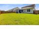 A spacious, grassy backyard featuring a screened-in porch at 142 Airy Dr, Summerville, SC 29486