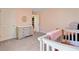 This bedroom has a changing table, closet, and light pink walls at 142 Airy Dr, Summerville, SC 29486