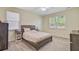 Bright bedroom with a cozy bed, neutral tones, and natural light from two windows at 142 Airy Dr, Summerville, SC 29486