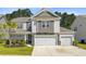 Charming two-story home with a landscaped yard and a three car attached garage at 142 Airy Dr, Summerville, SC 29486