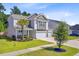 Charming two-story home with manicured lawn, a three-car garage, and lush landscaping at 142 Airy Dr, Summerville, SC 29486