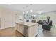 Modern kitchen with island seating and view into the living room at 142 Airy Dr, Summerville, SC 29486