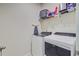 Functional laundry room equipped with modern washer and dryer units, shelving, and storage space at 142 Airy Dr, Summerville, SC 29486