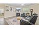 Comfortable living room featuring a fireplace, large screen TV, and luxurious leather seating at 142 Airy Dr, Summerville, SC 29486