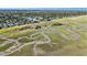 Aerial view of a waterfront community with lush greenery and a long pier stretching into the marsh at 1491 Tomato Farm Cir, Mount Pleasant, SC 29464