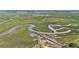 Expansive aerial view showcasing a wooden walkway through lush green marshland and winding waterways at 1491 Tomato Farm Cir, Mount Pleasant, SC 29464