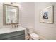 Chic powder room with shiplap walls, decorative mirror, and stylish vanity at 1491 Tomato Farm Cir, Mount Pleasant, SC 29464