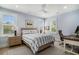 Bedroom with blue walls, ceiling fan, plantation shutters, and a comfy workspace at 1491 Tomato Farm Cir, Mount Pleasant, SC 29464