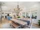 Open dining space with wood floors, an adjacent kitchen, and plenty of natural light at 1491 Tomato Farm Cir, Mount Pleasant, SC 29464