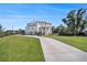 A long driveway leads up to this beautiful two-story home with an attached three-car garage at 1491 Tomato Farm Cir, Mount Pleasant, SC 29464