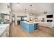 Open-concept kitchen featuring a large island, stainless steel appliances, and seamless flow to the living area at 1491 Tomato Farm Cir, Mount Pleasant, SC 29464