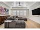 Living room featuring a large gray corduroy sectional sofa and modern ceiling fan at 1491 Tomato Farm Cir, Mount Pleasant, SC 29464