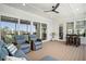 Relaxing screened porch with comfortable seating, ceiling fan, and outdoor access at 1491 Tomato Farm Cir, Mount Pleasant, SC 29464