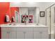 Bathroom featuring double sinks, sleek white cabinets, decorative mirror and glass enclosed shower at 160 Greenbelt Ct, Summerville, SC 29485