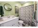 Bathroom featuring a shower with floral shower curtain, decorative mirror, and green painted walls at 160 Greenbelt Ct, Summerville, SC 29485