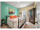 Cozy bedroom featuring light green walls, carpet flooring and a metal bedframe at 160 Greenbelt Ct, Summerville, SC 29485