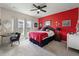 Primary bedroom with striking red accent wall, plush carpet and natural light from the windows at 160 Greenbelt Ct, Summerville, SC 29485