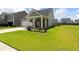 Lovely exterior view with well-maintained landscaping, a covered porch, and an attached two-car garage at 160 Greenbelt Ct, Summerville, SC 29485