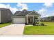 Charming single-Gathering home features a well-manicured lawn, covered porch, and an attached two-car garage at 160 Greenbelt Ct, Summerville, SC 29485