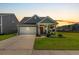 Charming single-Gathering home features a well-manicured lawn, covered porch, and an attached two-car garage at sunset at 160 Greenbelt Ct, Summerville, SC 29485