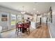 Open-concept kitchen with white cabinets, stainless steel appliances, and adjacent dining area with natural light at 160 Greenbelt Ct, Summerville, SC 29485